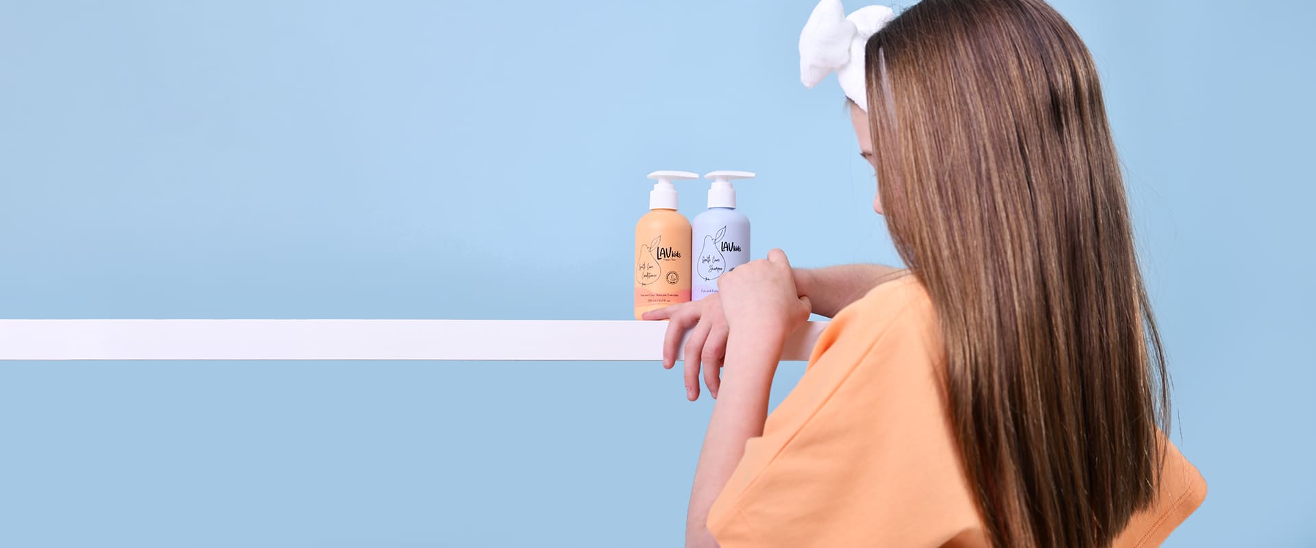 Small girl facing towards two products